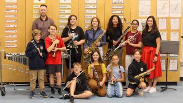 Chief Dan George - MusiCounts Grant Group of students holding new instruments, alongside their teacher and another adult