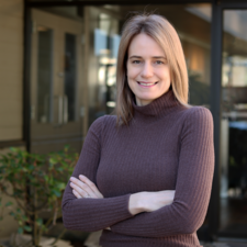 Woman wearing brown turtleneck with blonde hair