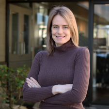 Kate Muir, HR Manager Woman wearing brown turtleneck with blonde hair
