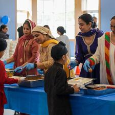 Students in line, receiving their food from the PAC
